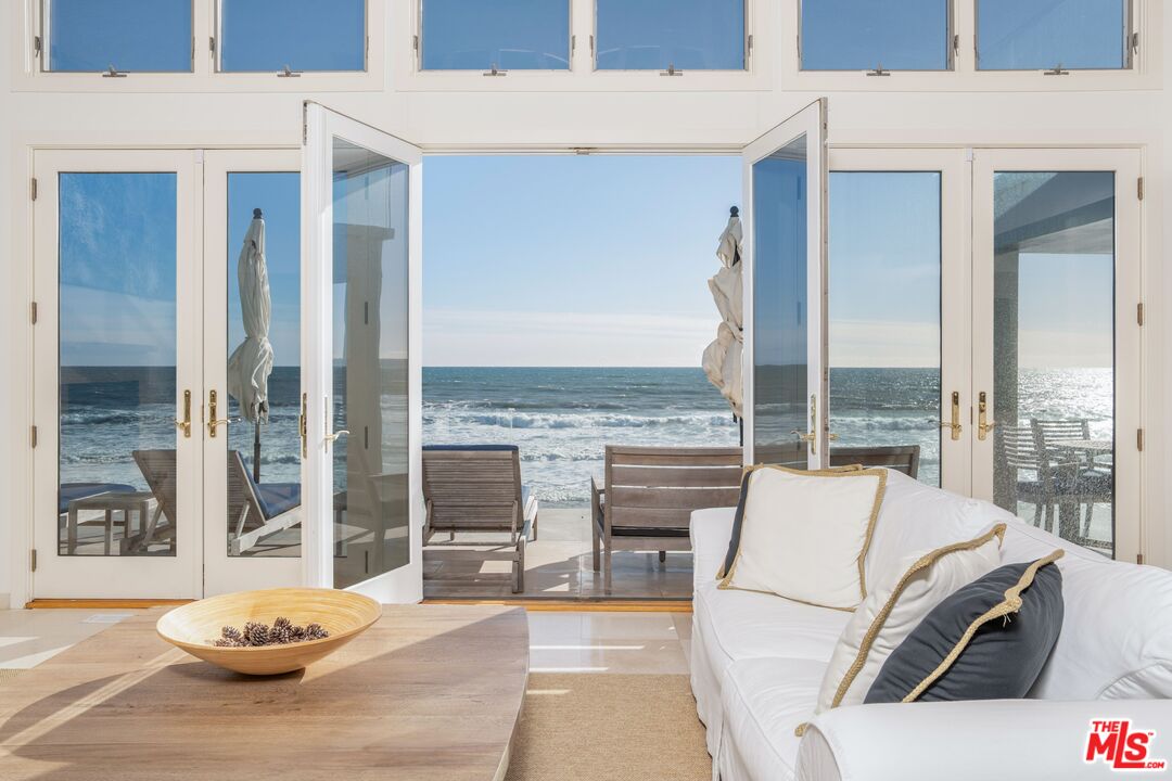 24456 Malibu Road Malibu, CA 90265 - Photo 6 of 33 a living room with furniture and a floor to ceiling window