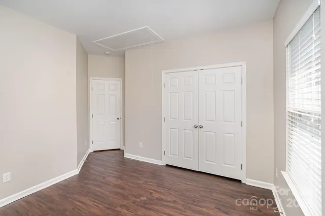 a view of an empty room and wooden floor