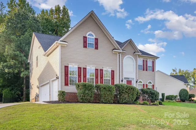 a front view of house with yard and green space