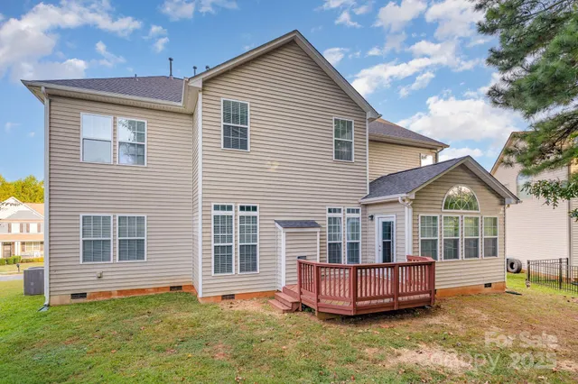a view of a house with a yard and sitting area