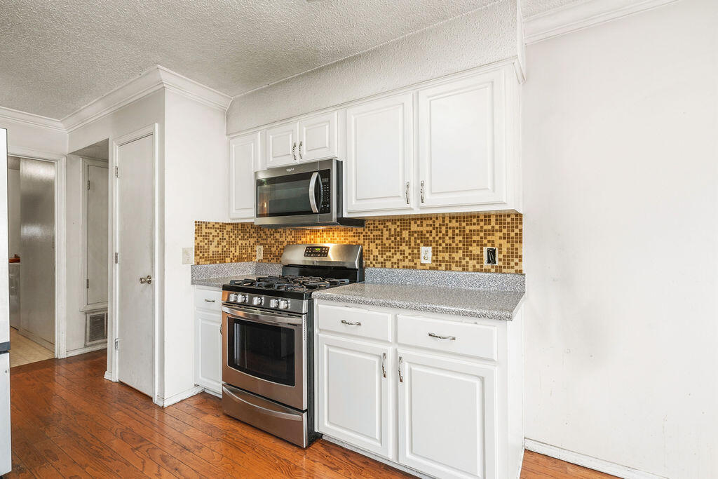 53 4th Street Shalimar, FL 32579 - Photo 14 of 47 a kitchen with white cabinets and appliances