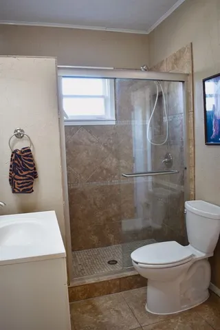 a bathroom with a toilet and a shower