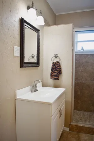a bathroom with a sink a vanity and a mirror