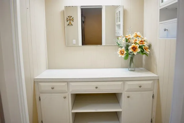 a bedroom with a bed and a dresser in it