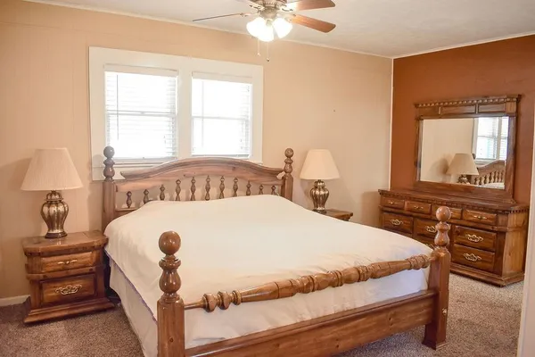 a bedroom with a bed and a window