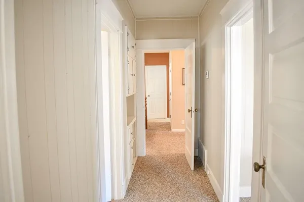 a large bed in a bedroom next to a window