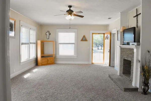 a view of empty room with windows and fireplace