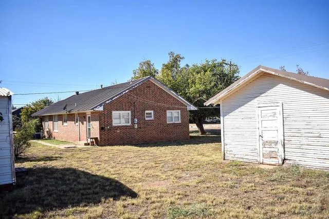 a house that has a tree in front of it