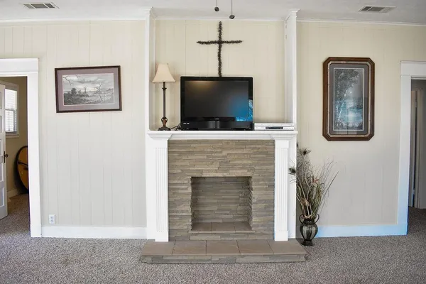 a living room with a fireplace and a flat screen tv