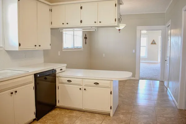 a kitchen with granite countertop white cabinets and white appliances
