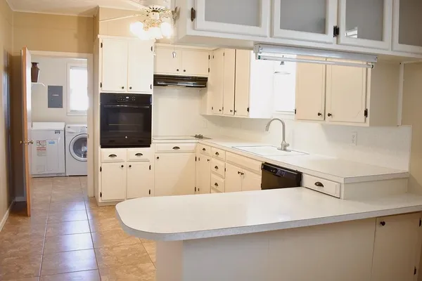 a kitchen with a cabinets and white appliances