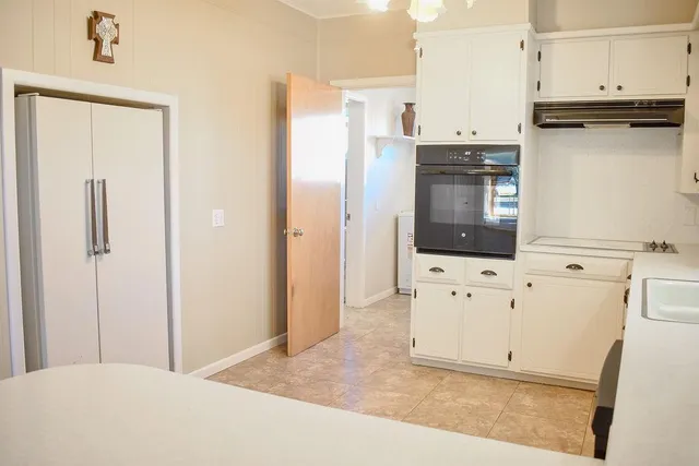a view of a kitchen with cabinets
