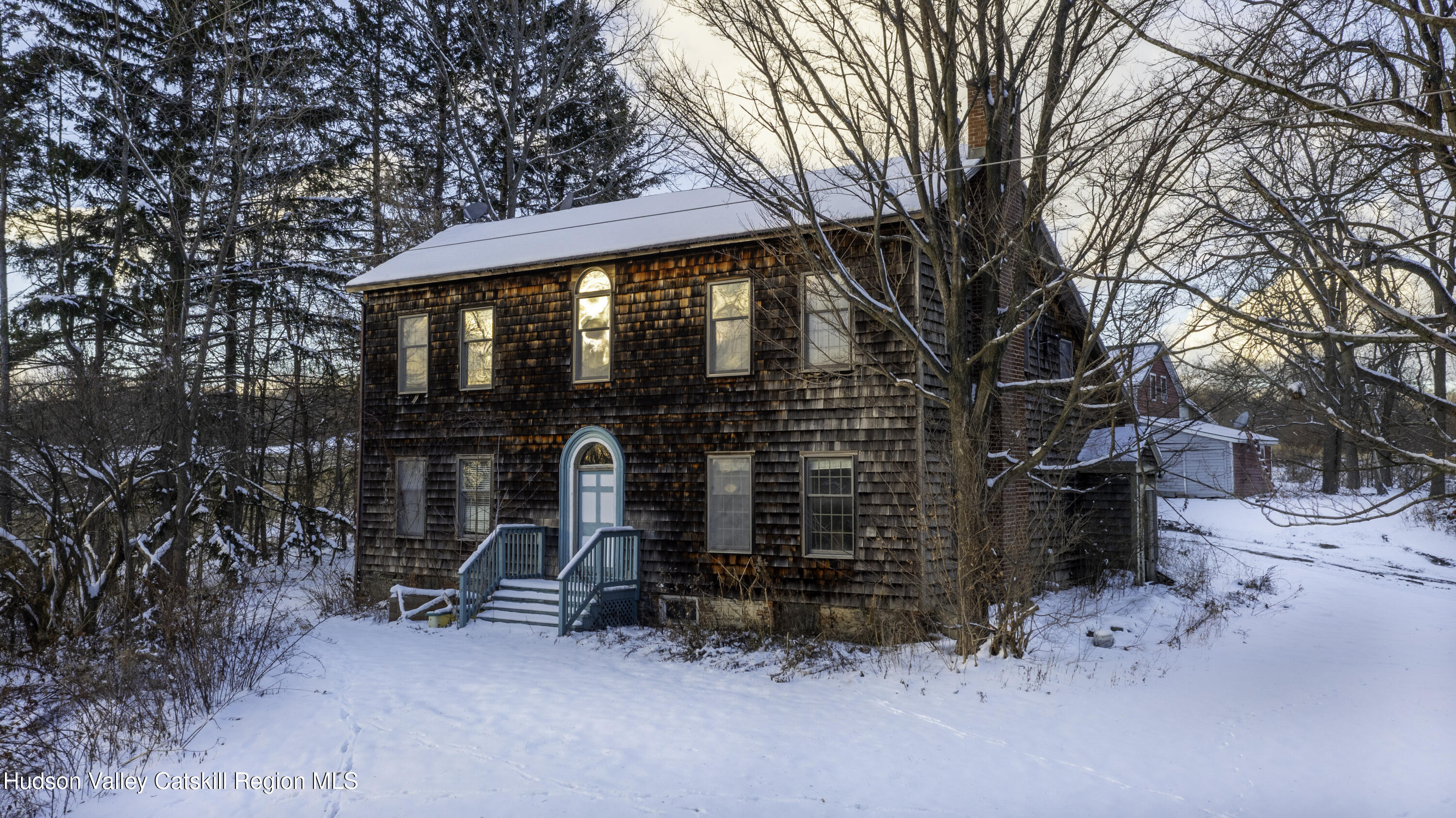 90 West End Road Hillsdale, NY 12529 - Photo 1 of 10 a small barn with a table and chairs under an umbrella
