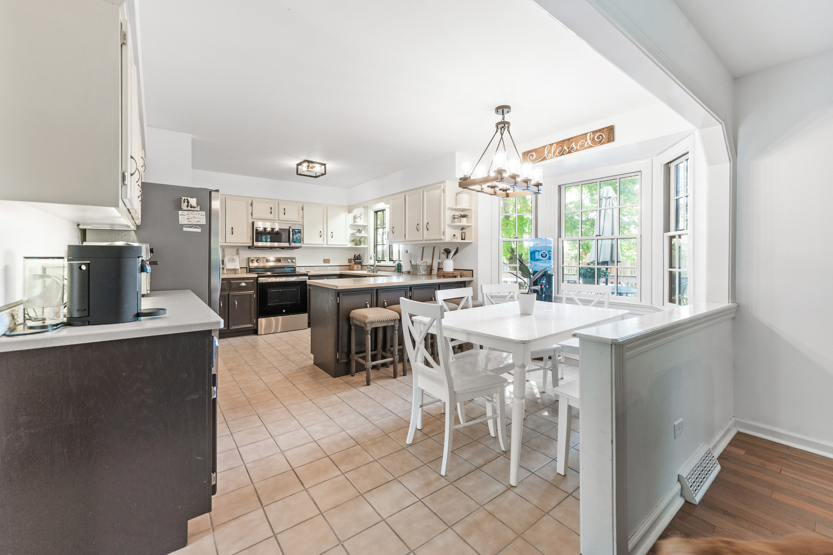 560 Renee Court Geneva, IL 60134 - Photo 13 of 50 a kitchen with stainless steel appliances a table and chairs in it