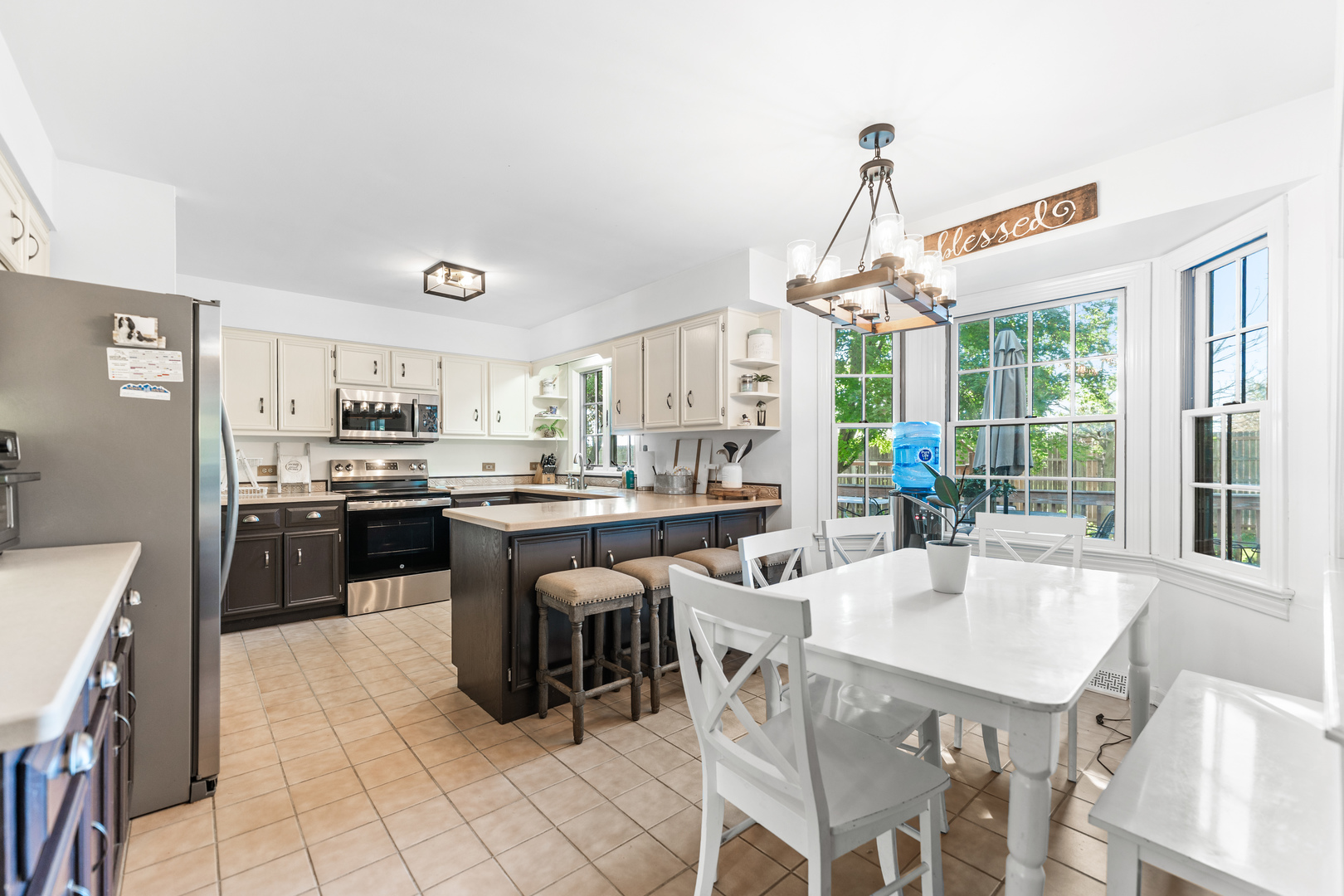 560 Renee Court Geneva, IL 60134 - Photo 14 of 50 a kitchen with kitchen island granite countertop a sink and a stove