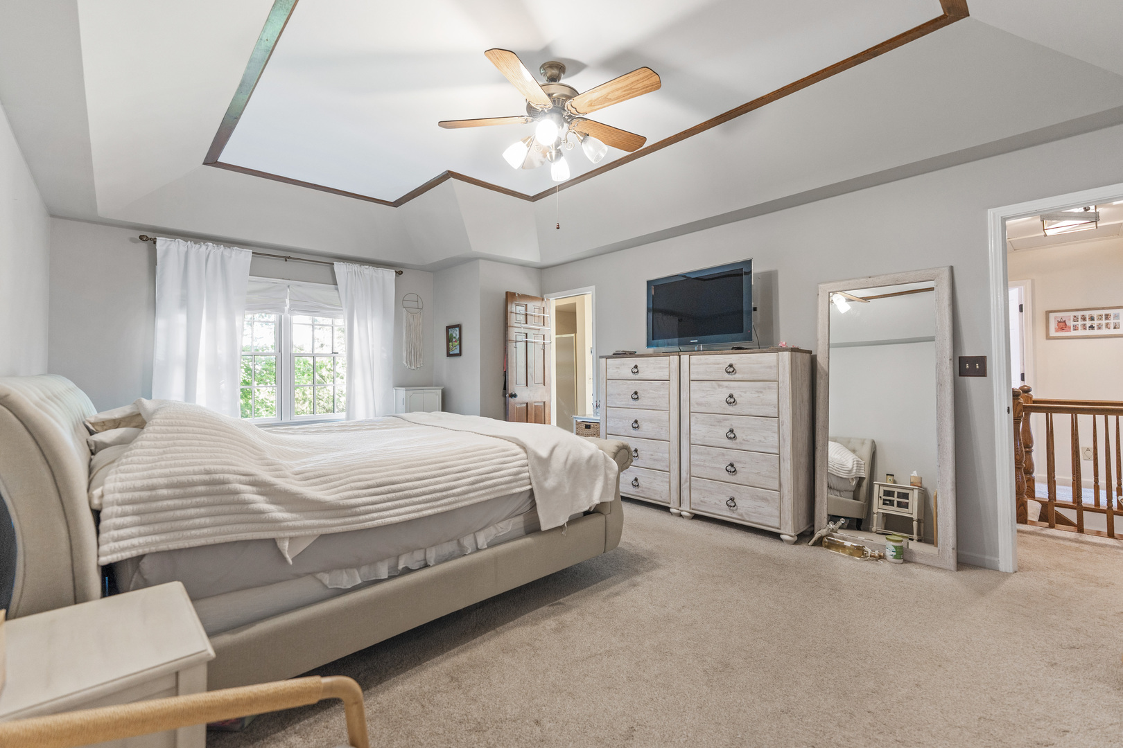 560 Renee Court Geneva, IL 60134 - Photo 27 of 50 a spacious bedroom with a bed and a flat screen tv
