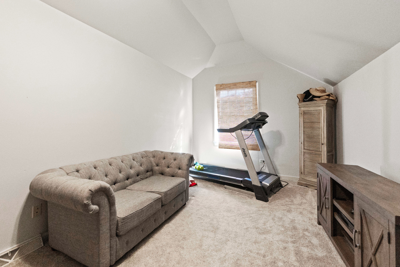 560 Renee Court Geneva, IL 60134 - Photo 31 of 50 a living room with furniture gym equipment and a wooden floor