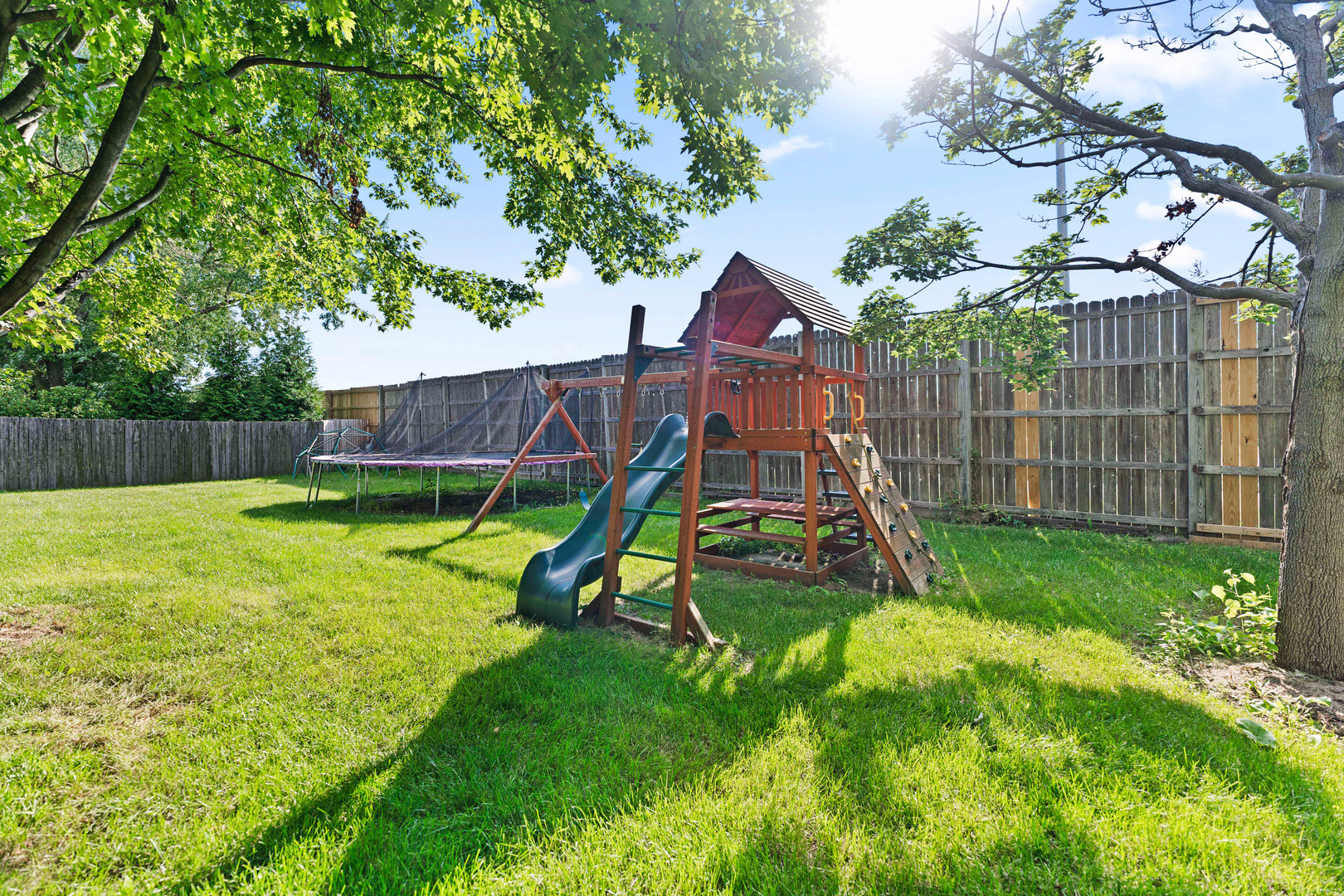 560 Renee Court Geneva, IL 60134 - Photo 45 of 50 a view of a backyard with a slide and a tree