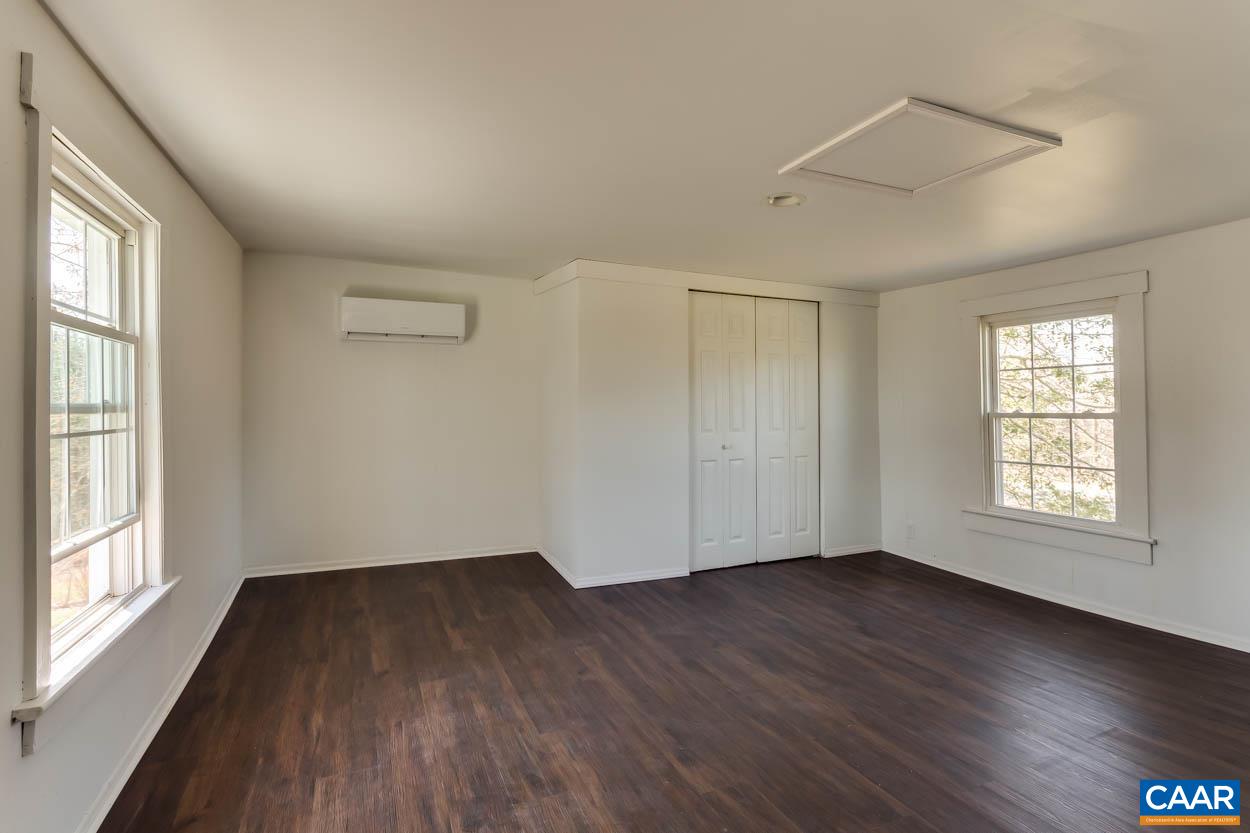 3810 South Constitution Route Dillwyn, VA 23936 - Photo 13 of 45 a view of an empty room with wooden floor and a window