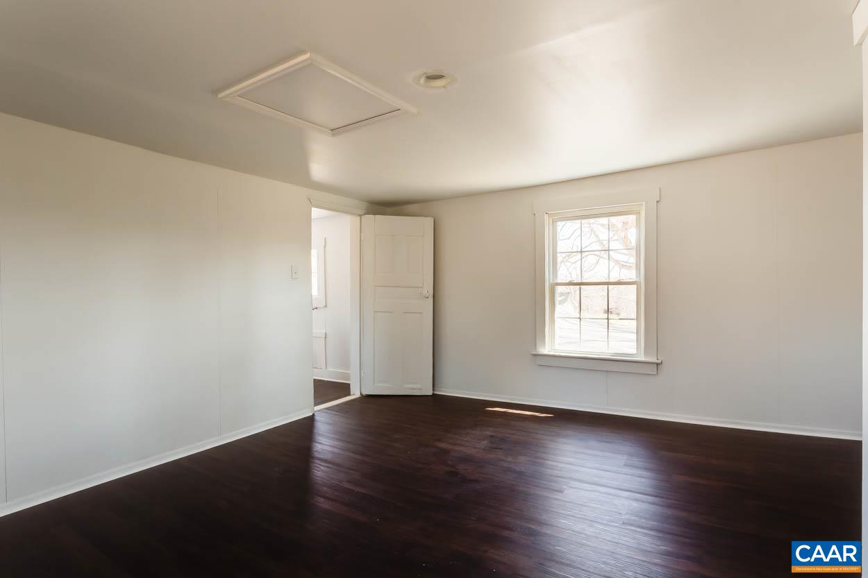 3810 South Constitution Route Dillwyn, VA 23936 - Photo 14 of 45 an empty room with wooden floor and windows