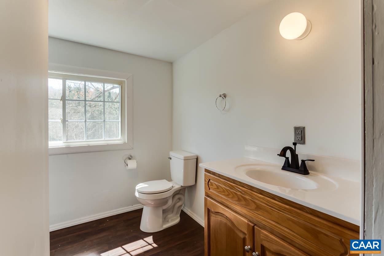 3810 South Constitution Route Dillwyn, VA 23936 - Photo 23 of 45 a bathroom with a sink a toilet and a window