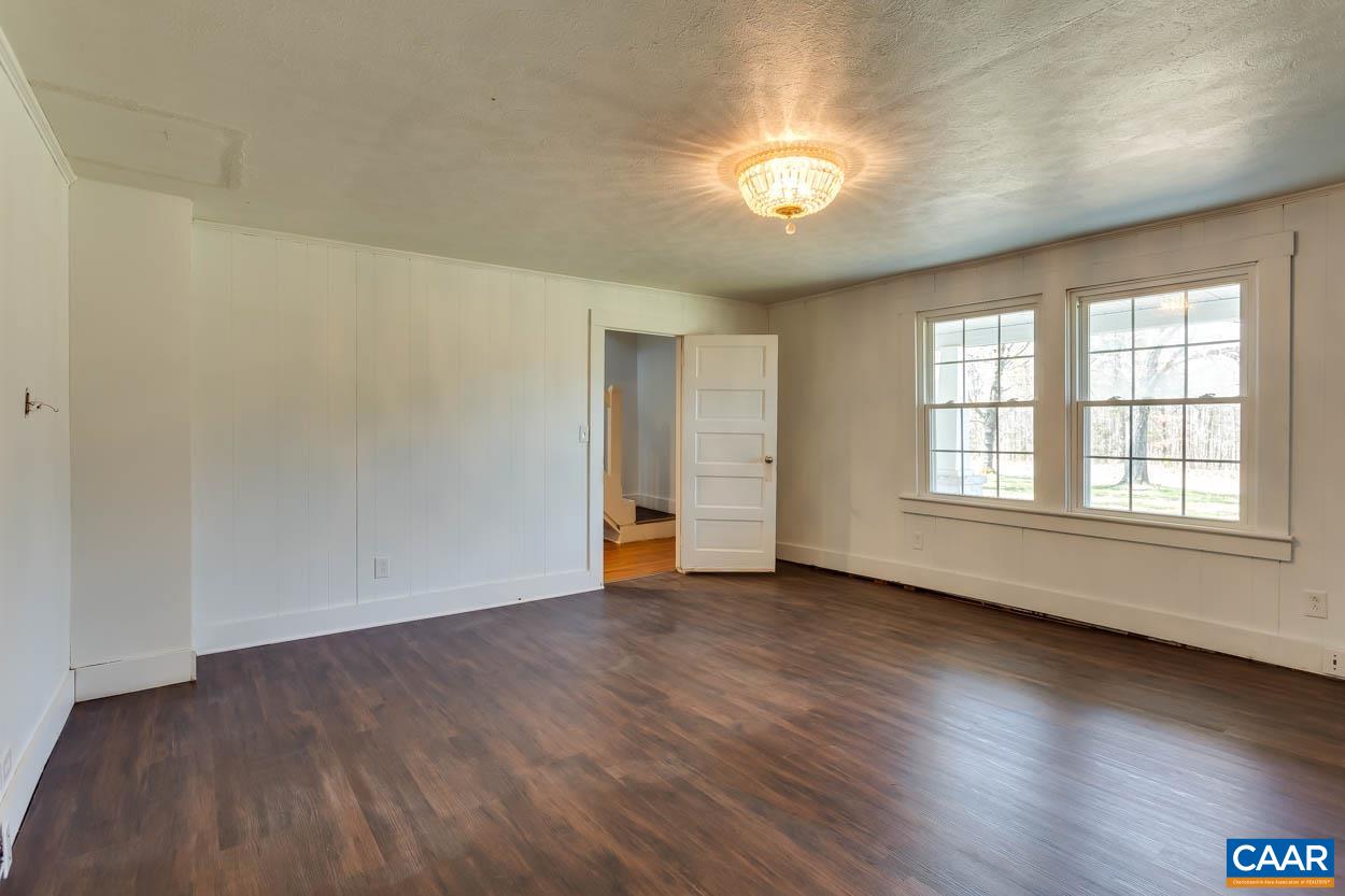 3810 South Constitution Route Dillwyn, VA 23936 - Photo 10 of 45 an empty room with wooden floor and windows