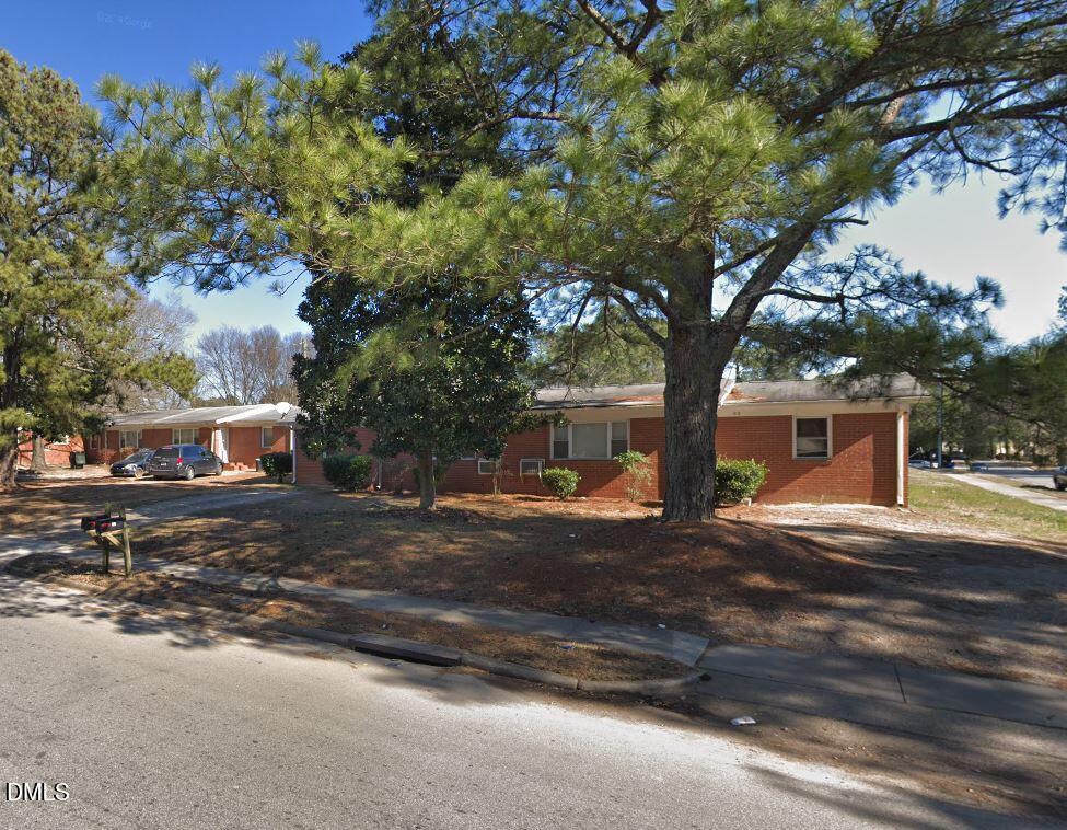 411 Rose Lane Raleigh, NC 27610 - Photo 1 of 12 a tree in the middle of a yard