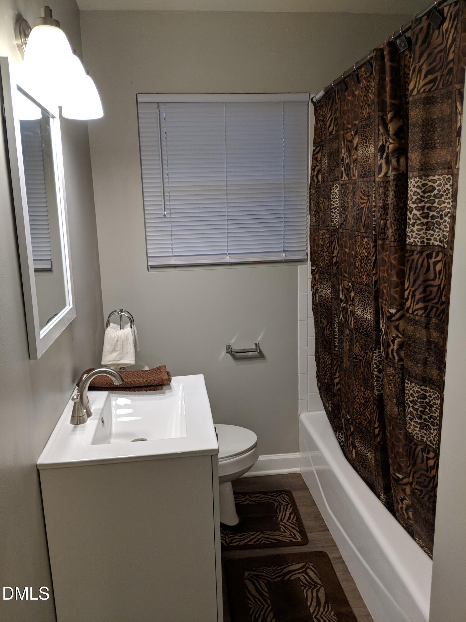 411 Rose Lane Raleigh, NC 27610 - Photo 11 of 12 a bathroom with a sink toilet and shower