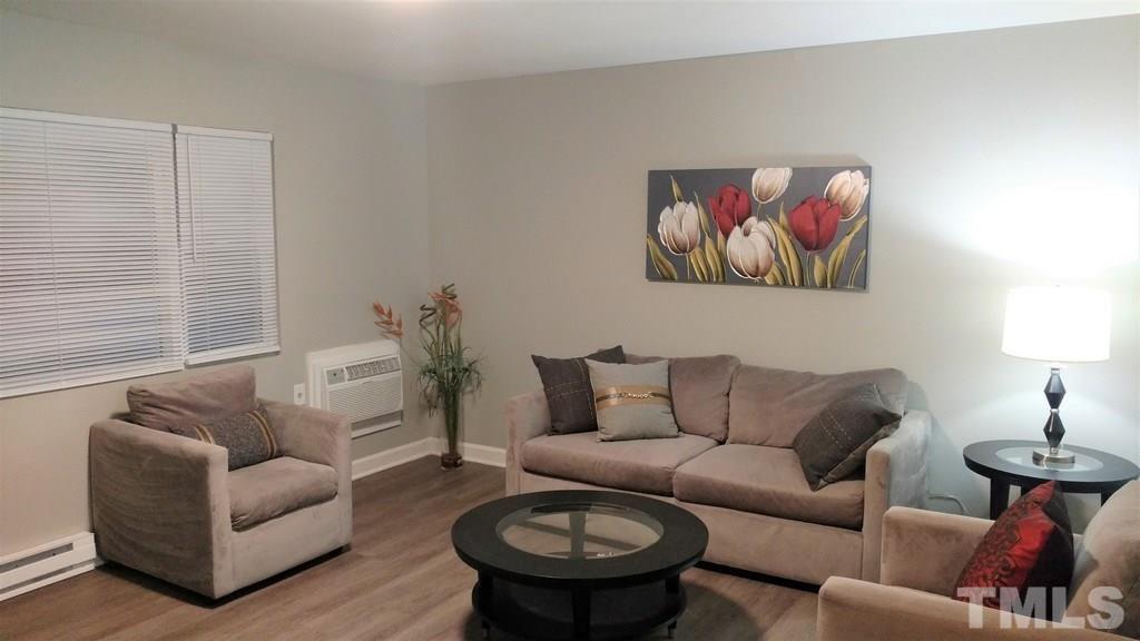411 Rose Lane Raleigh, NC 27610 - Photo 3 of 12 a living room with furniture and a couch