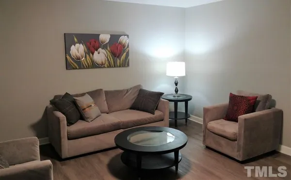 a living room with furniture a couch and painting on the wall