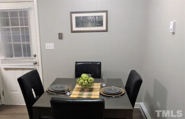 a view of a dining room with furniture and wooden floor