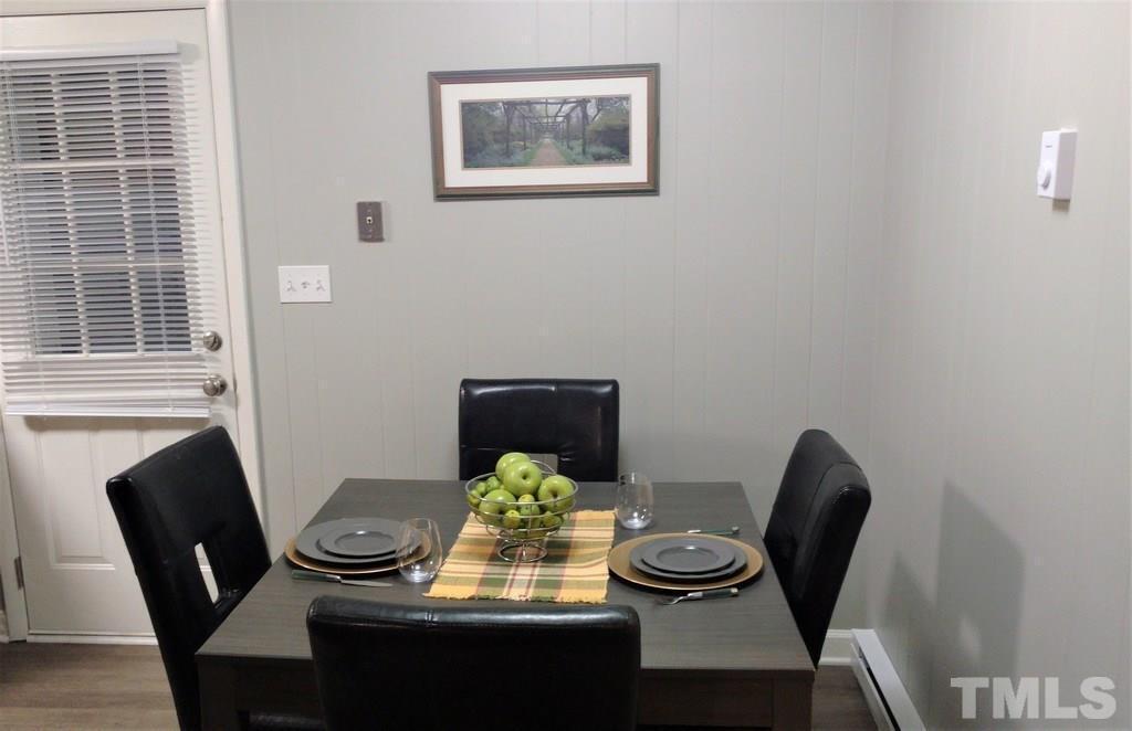 411 Rose Lane Raleigh, NC 27610 - Photo 5 of 12 a view of a dining room with furniture and wooden floor