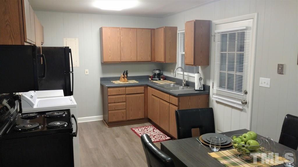 411 Rose Lane Raleigh, NC 27610 - Photo 7 of 12 a kitchen with a sink stove and refrigerator