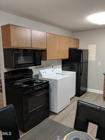 a kitchen with a stove microwave and refrigerator