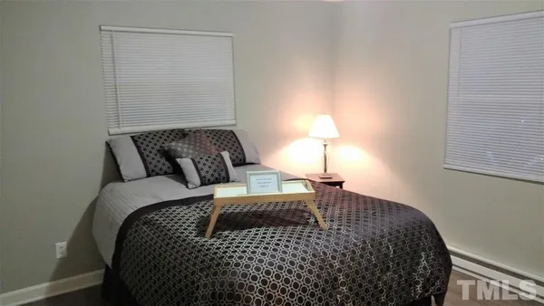 a bedroom with a bed and a lamp