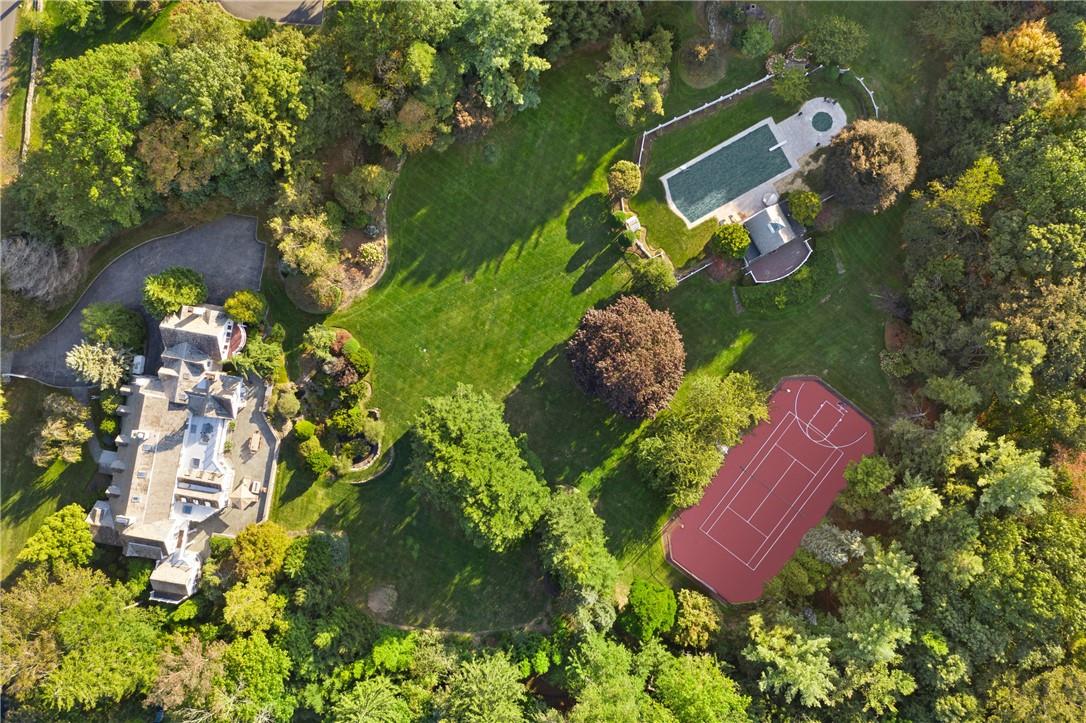 28 Pleasant Ridge Road Harrison, NY 10528 - Photo 1 of 1 an aerial view of a house with a yard and a garden