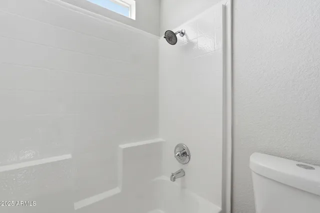 a bathroom with a shower and toilet
