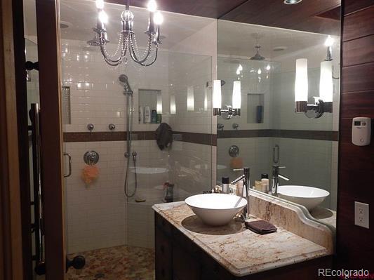 181 Doe Circle South Fork, CO 81154 - Photo 30 of 35 a bathroom with a granite countertop sink a toilet and shower