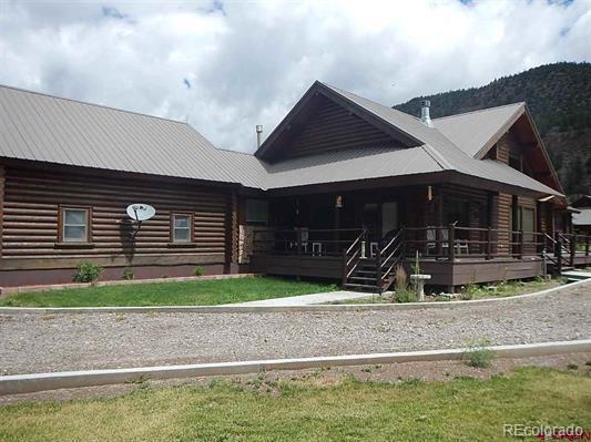 181 Doe Circle South Fork, CO 81154 - Photo 3 of 35 a front view of a house with garden