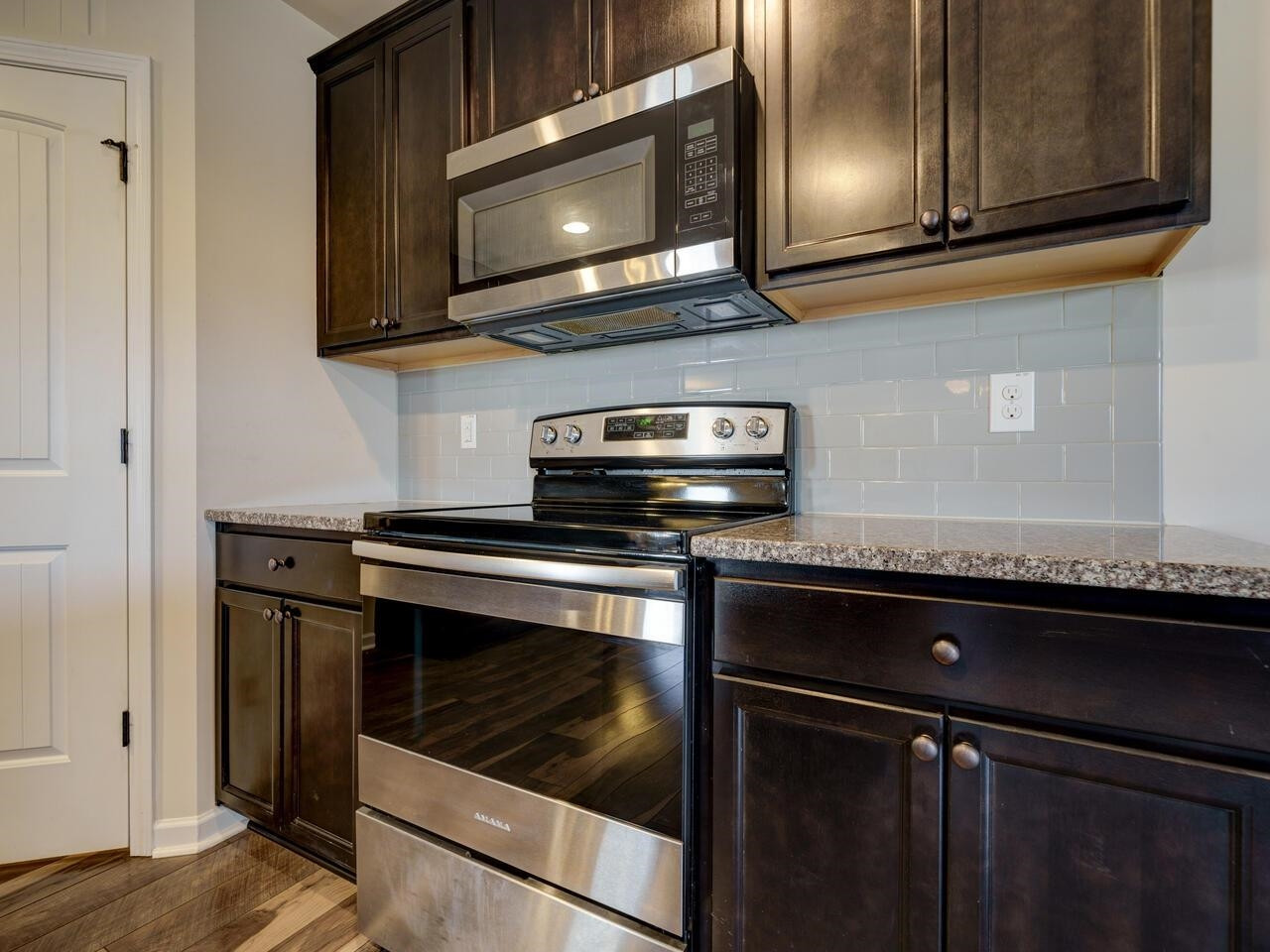 8167 Feldwig Place Raleigh, NC 27616 - Photo 13 of 51 Open and Bright. Granite Counters, SS Appliances, Walk in Pantry, Subway Tile Backsplash, Large Island, Tons of Cabinets and Counter Space. Kitchen