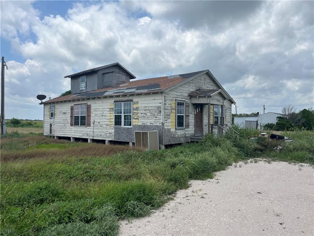 5469 War Bonnet Drive Robstown, TX 78380 - Photo 1 of 12 a front view of a house with a garden