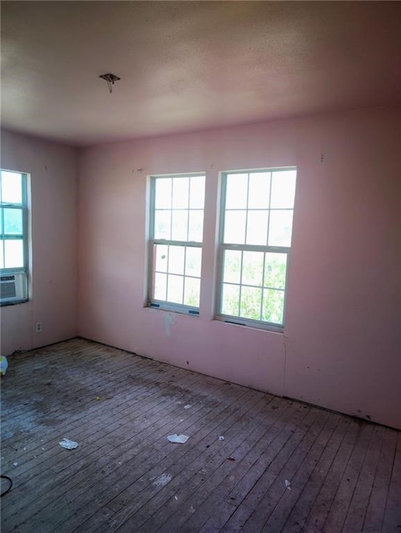 5469 War Bonnet Drive Robstown, TX 78380 - Photo 5 of 12 an empty room with wooden floor and windows