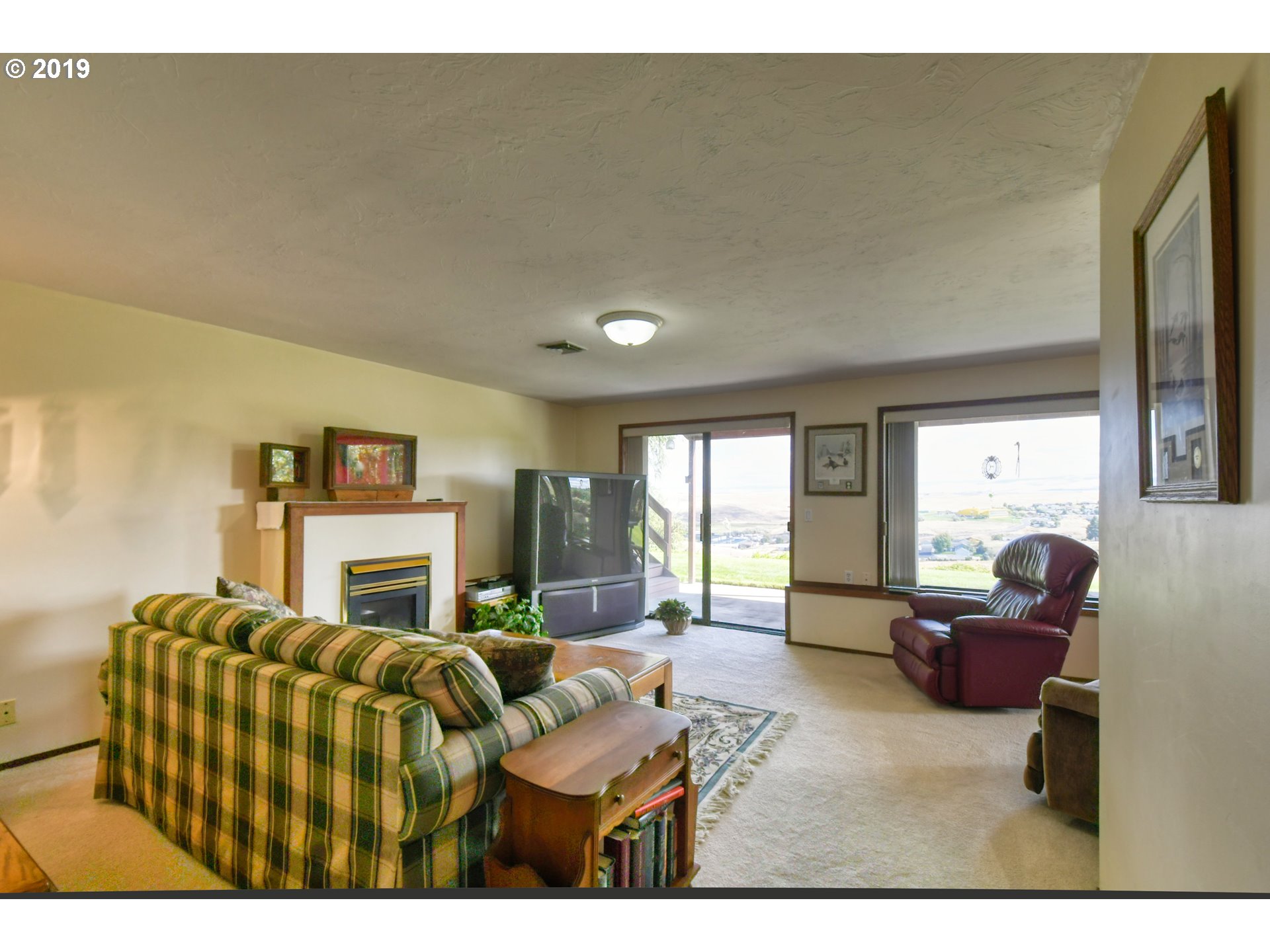 1610 Southwest 18th Street Pendleton, OR 97801 - Photo 17 of 32 a living room with furniture two large windows and a fireplace