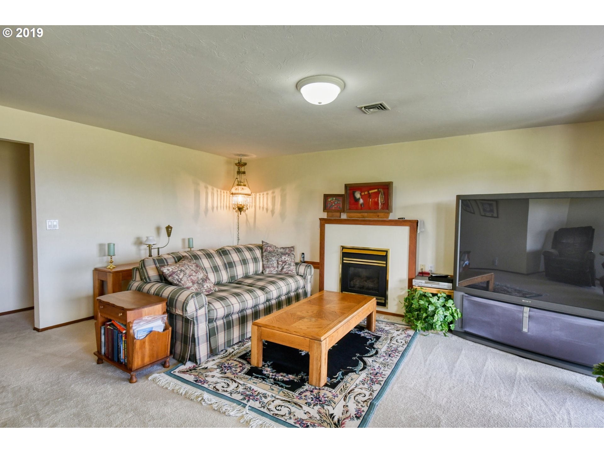 1610 Southwest 18th Street Pendleton, OR 97801 - Photo 18 of 32 a living room with furniture a flat screen tv and a fireplace