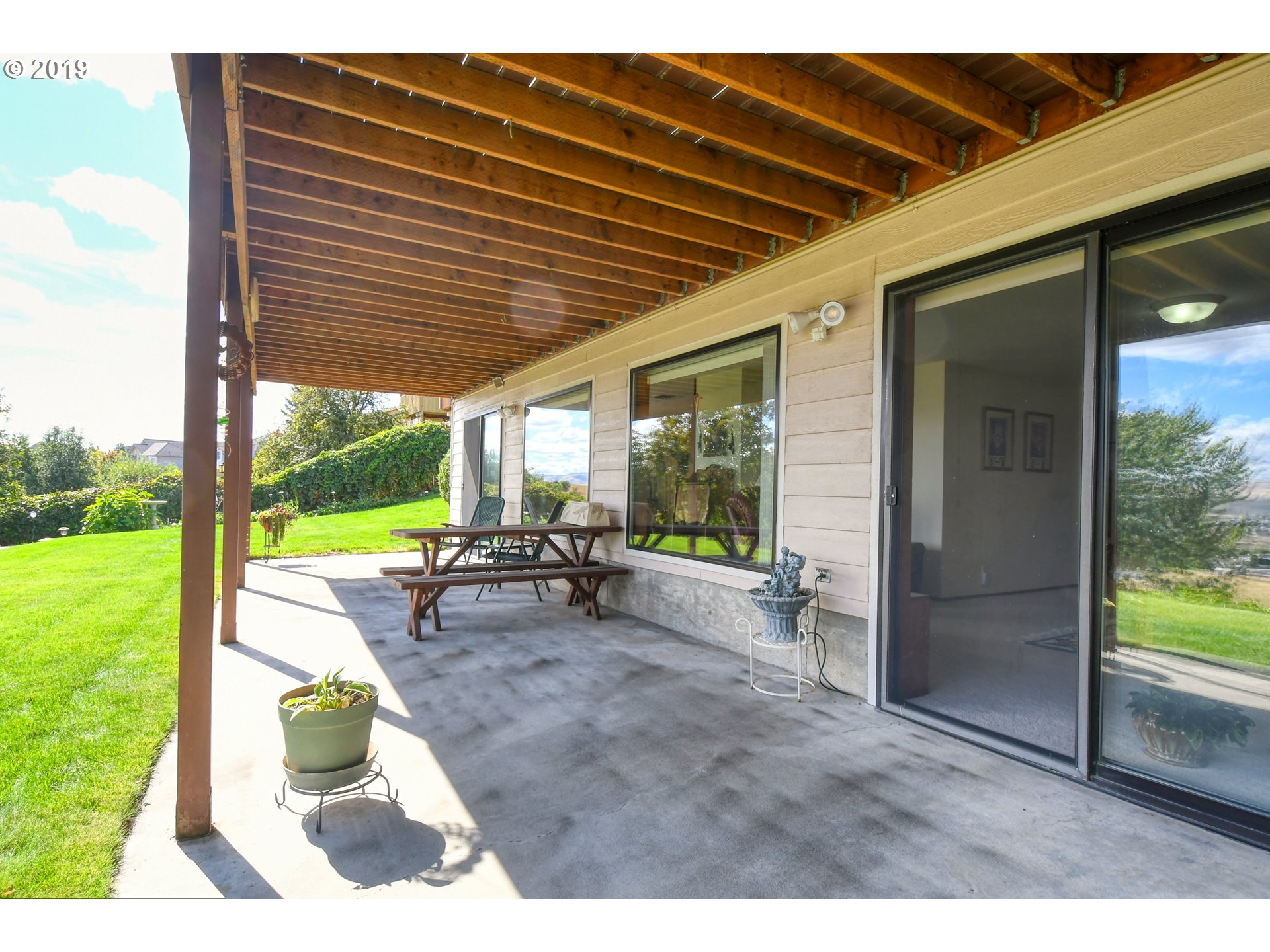 1610 Southwest 18th Street Pendleton, OR 97801 - Photo 27 of 32 a view of a patio with table and chairs next to a yard