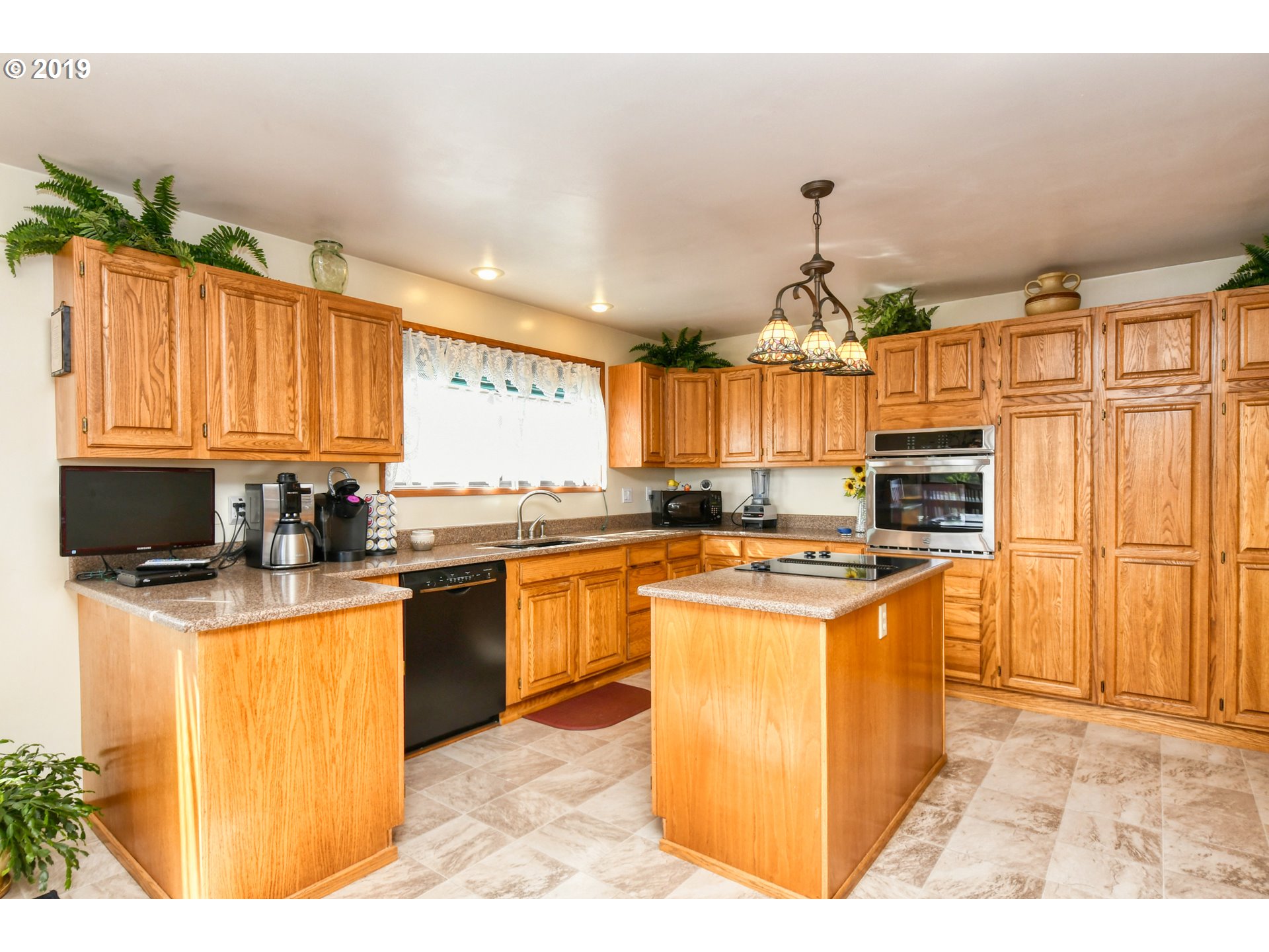 1610 Southwest 18th Street Pendleton, OR 97801 - Photo 7 of 32 a kitchen with stainless steel appliances granite countertop a stove a sink dishwasher and a refrigerator
