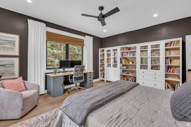 1766 West Tollgate Cyn Road Coalville, UT 84017 - Photo 15 of 59 Spacious room featuring extensive built-in white cabinetry with glass-front doors, a dedicated workstation with a wood-finish desktop, and recessed lighting