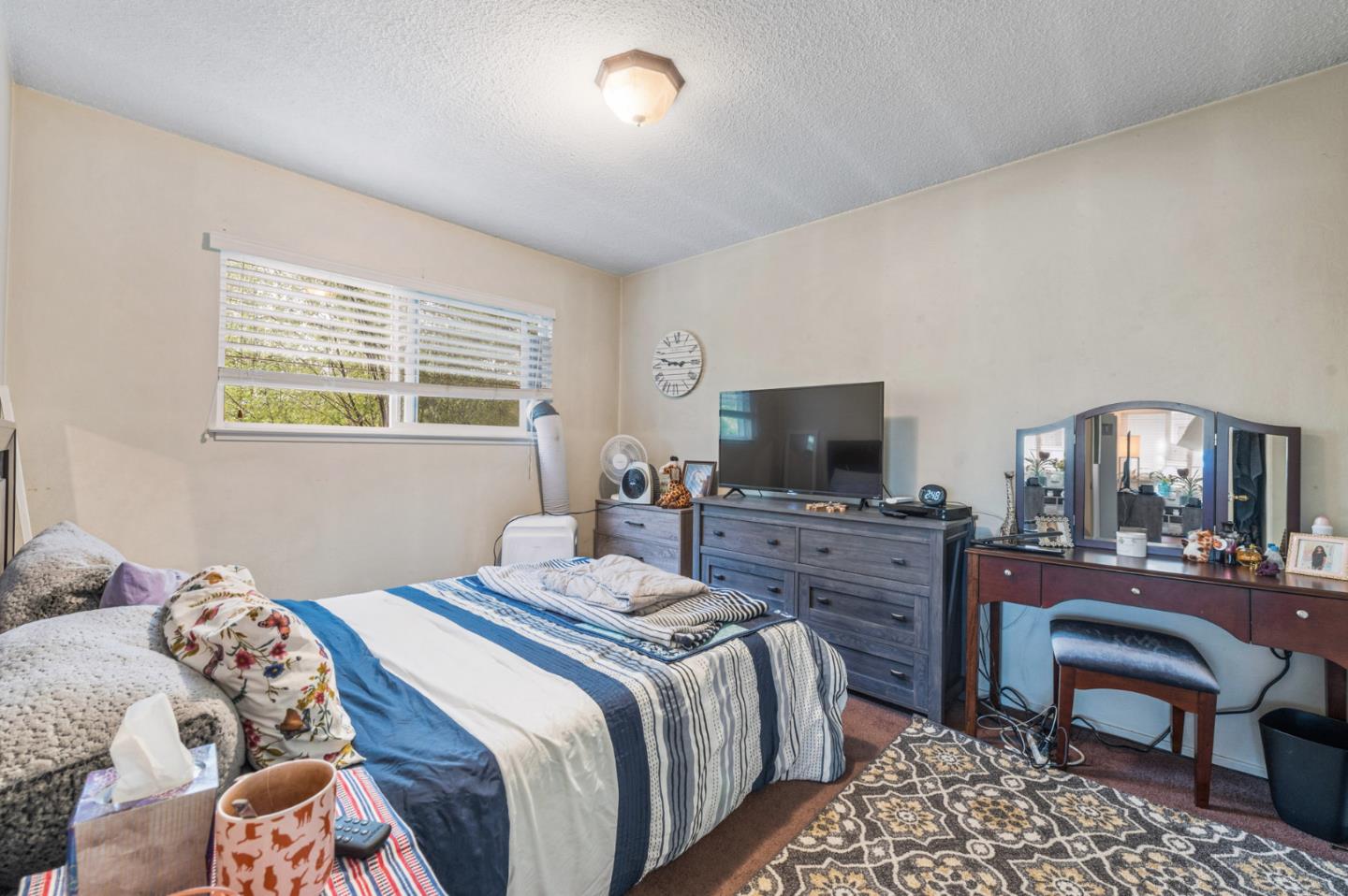 1830 48th Avenue Capitola, CA 95010 - Photo 12 of 32 a bedroom with a bed and a flat screen tv