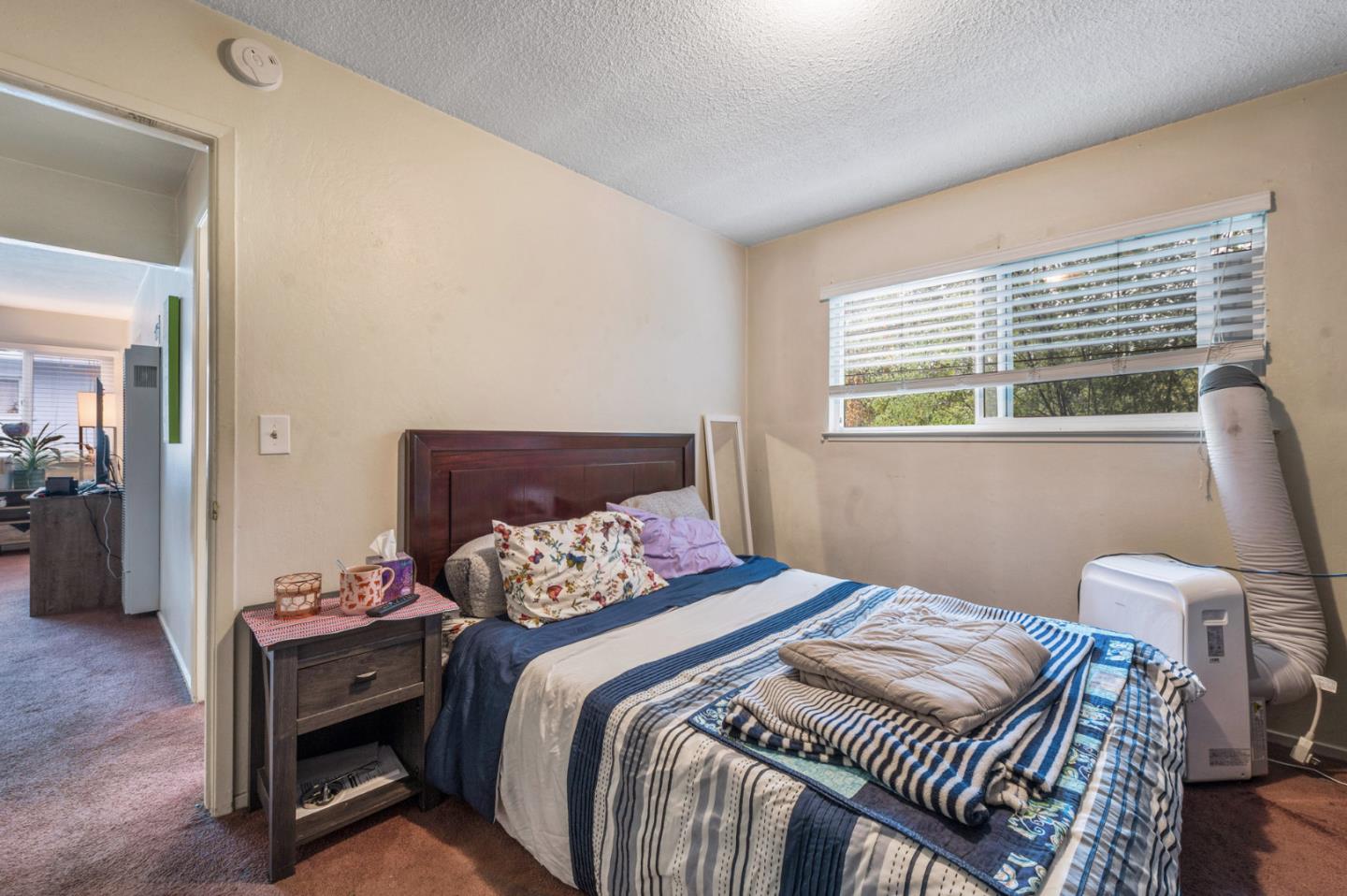1830 48th Avenue Capitola, CA 95010 - Photo 13 of 32 a bedroom with a bed and wooden floor