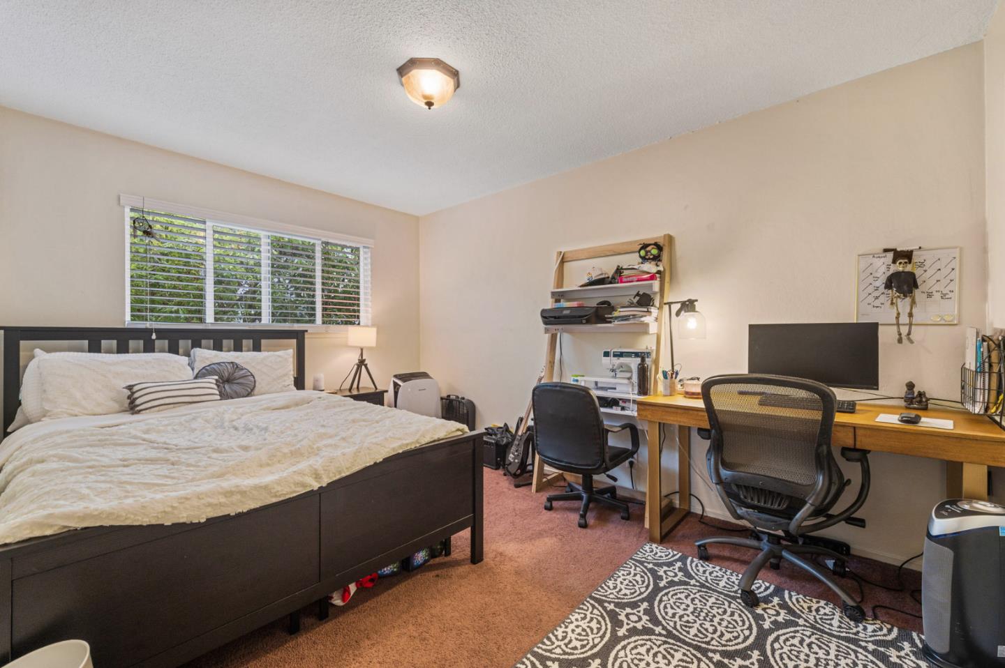 1830 48th Avenue Capitola, CA 95010 - Photo 14 of 32 a bedroom with a bed and a computer on a desk next to a large window